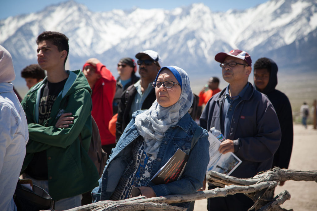 Attendees of the 48th Manzanar Pilgrimage listen to the program inside the camp’s cemetery. Photo by Joanne Kim