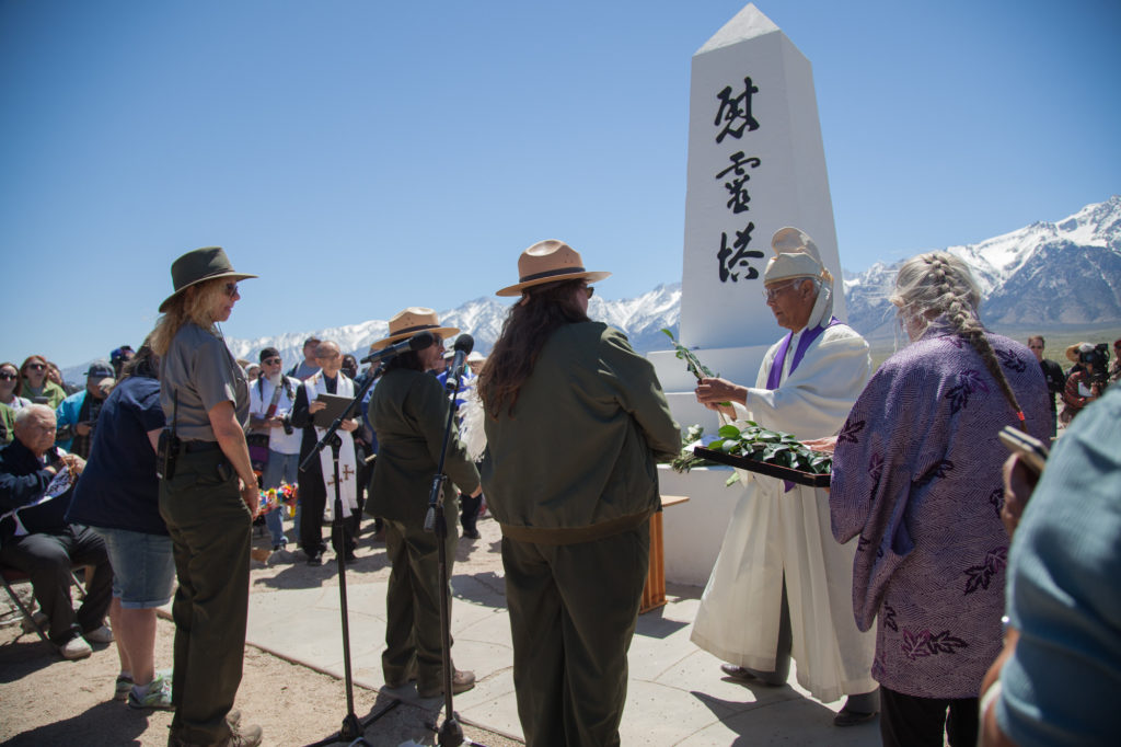 During the Shinto ceremony, National Park Rangers are given leaves to place on the I Rei To monument to honor those who were interned at Manzanar. Rangers worked with the Japanese-American community in creating the Manzanar Historic Site’s Museum and the re-creation of the barracks and buildings. Photo by Joanne Kim