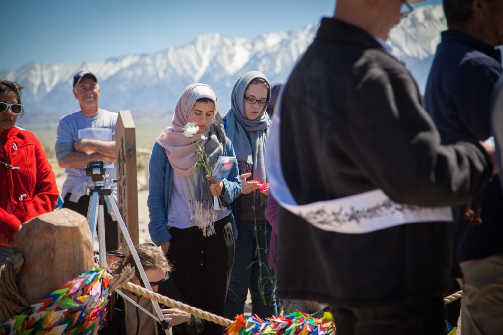 Attendees pray with the Buddhist ministers during the interfaith service at the Manzanar Pilgrimage. Photo by Joanne Kim