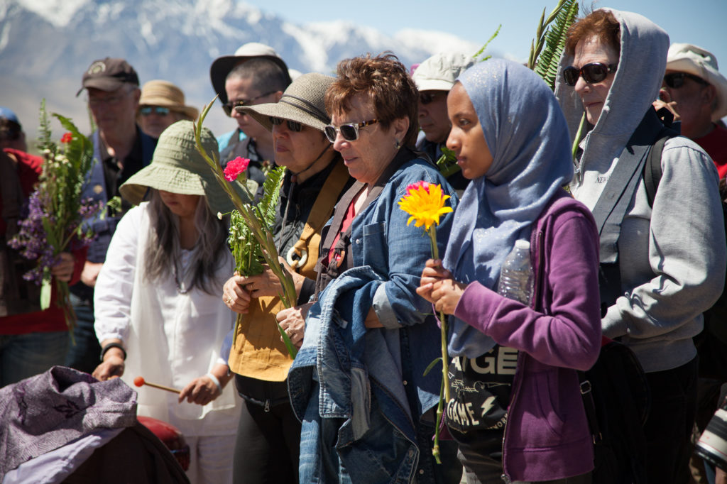 Attendees honor those who were interned at Manzanar during the interfaith service in the camp cemetery. Photo by Joanne Kim