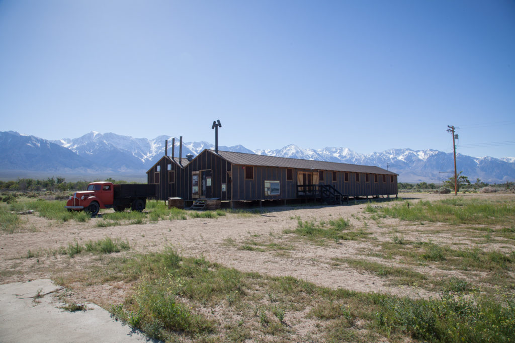 Recreation of the dining hall at the Manzanar camp located in a valley below the Eastern Sierras (background). Photo by Joanne Kim