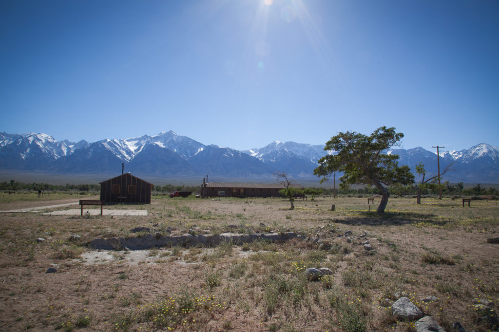 Recreation of the latrine and dining hall at the Manzanar concentration camp located in a valley below the Eastern Sierras (background). Photo by Joanne Kim