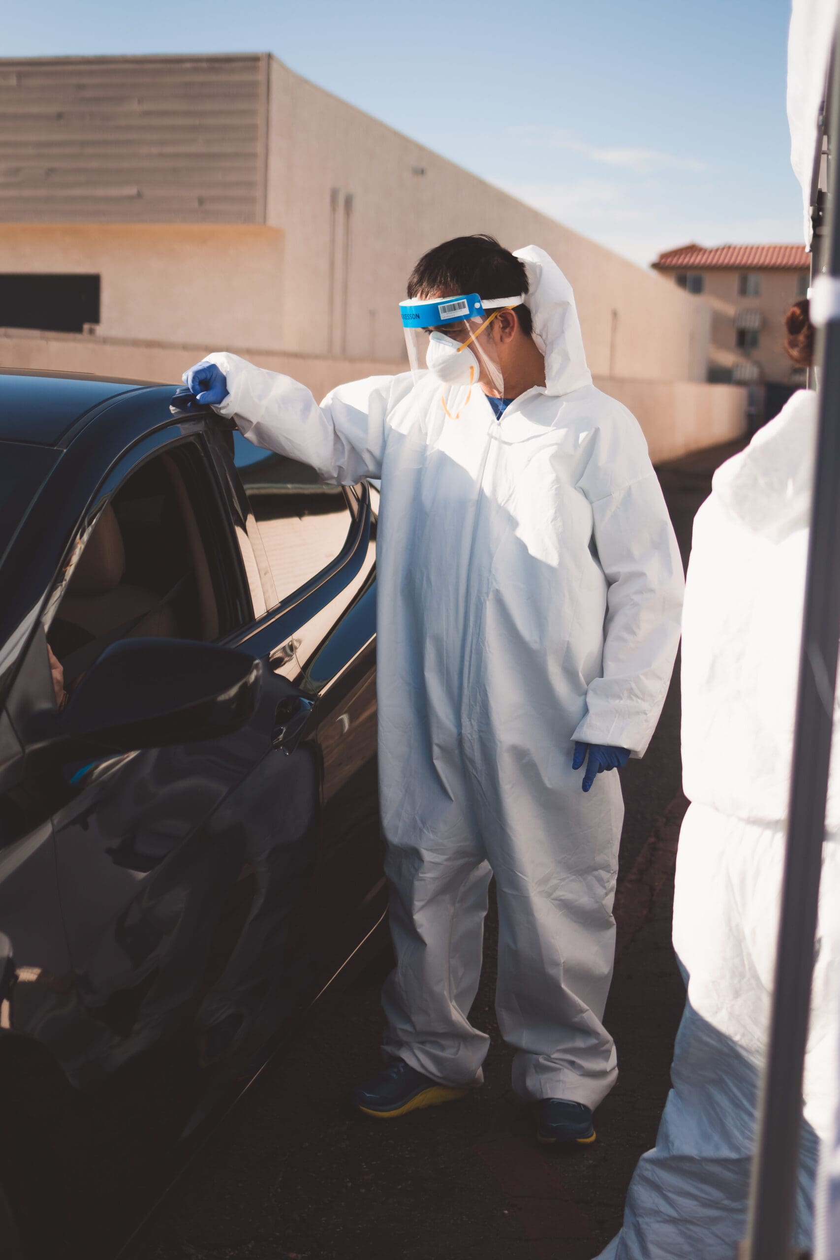 Dr. Tien Vo helps conduct drive-through COVID-19 testing outside his Calexico clinic. Photo by Rachel Avalos.Dr. Tien Vo helps conduct drive-through COVID-19 testing outside his Calexico clinic. Photo by Rachel Avalos.