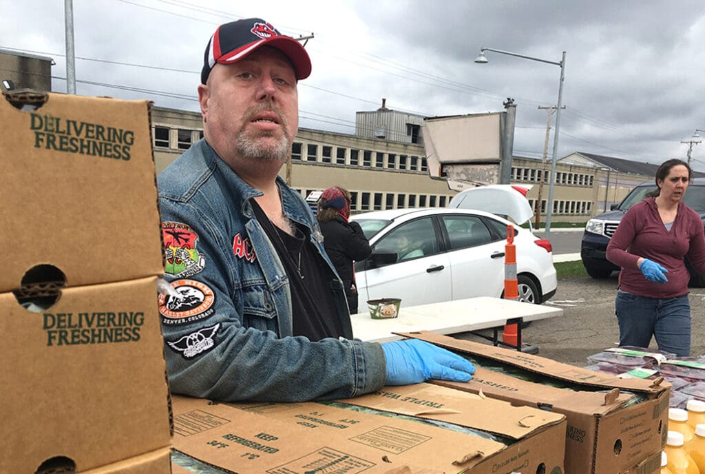 Richard Gilbertson, 49, volunteers at a drive-through food pantry organized by With God's Grace. Photo by Maki Somosot.