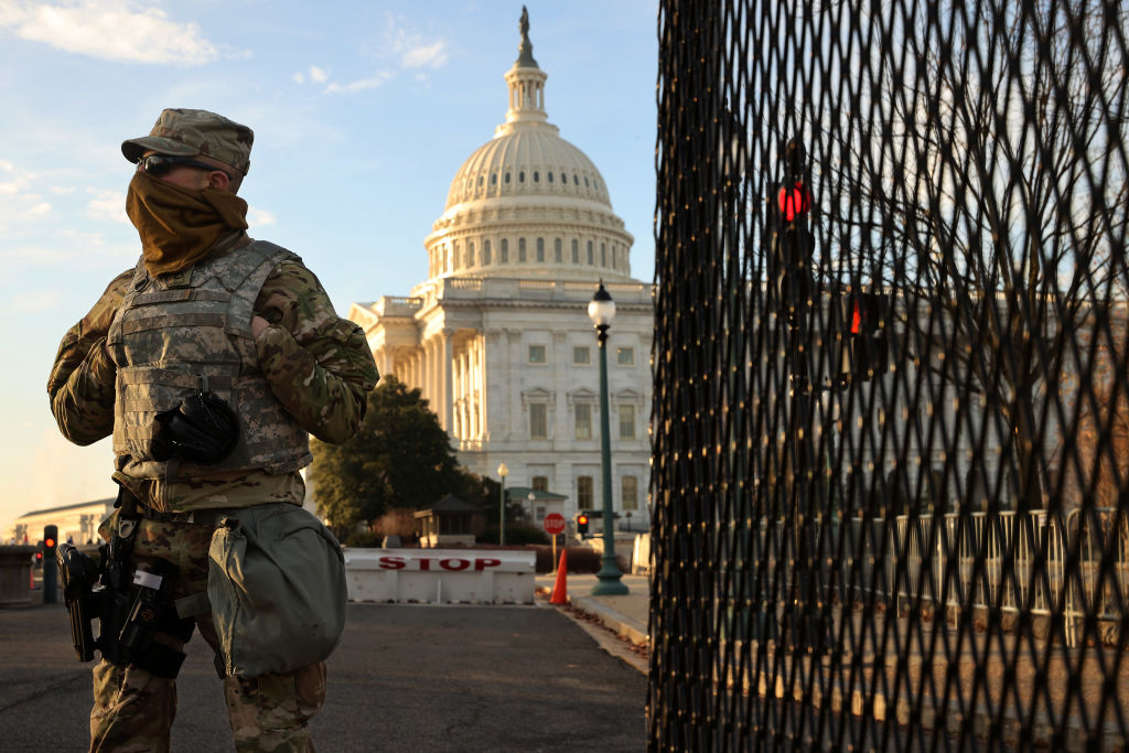 A member of the New York National Guard stands at a gate outside the U.S. Capitol the day after the House of Representatives voted to impeach President Donald Trump for the second time January 14, 2021 in Washington, DC.