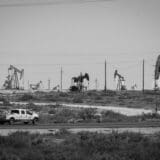 A truck drives in front of a few of the thousands of wells pulling up oil in the Loco Hills area of the Permian Basin north of Carlsbad, NM. Photo by Jerry Redfern.