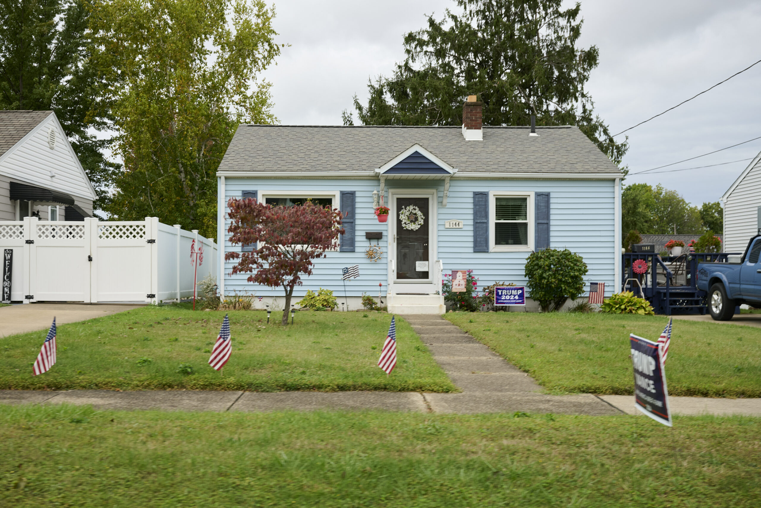 An Erie home is decorated with American flags and Trump signs.