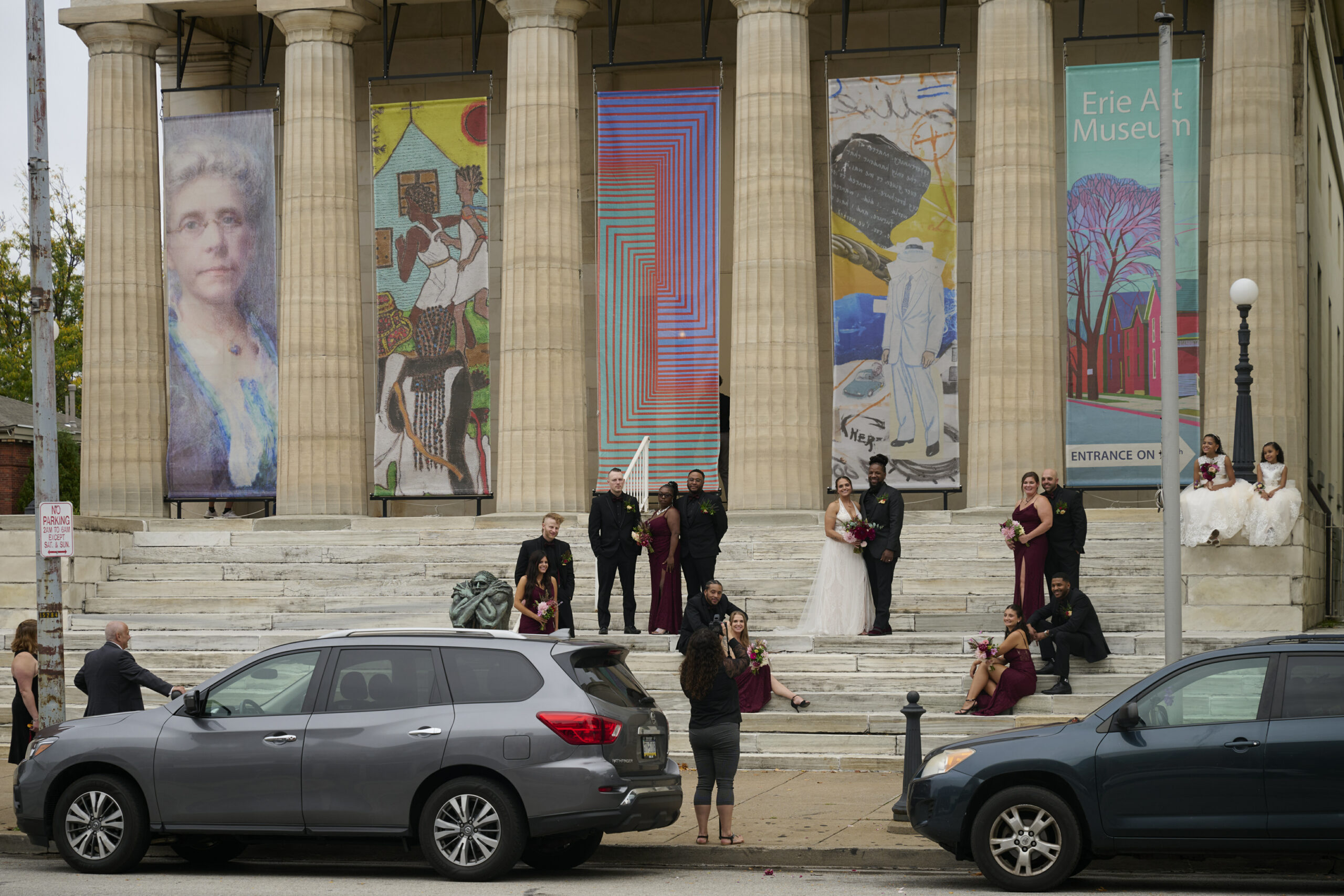 A bridal party has a photo shoot outside the Erie Art Museum.