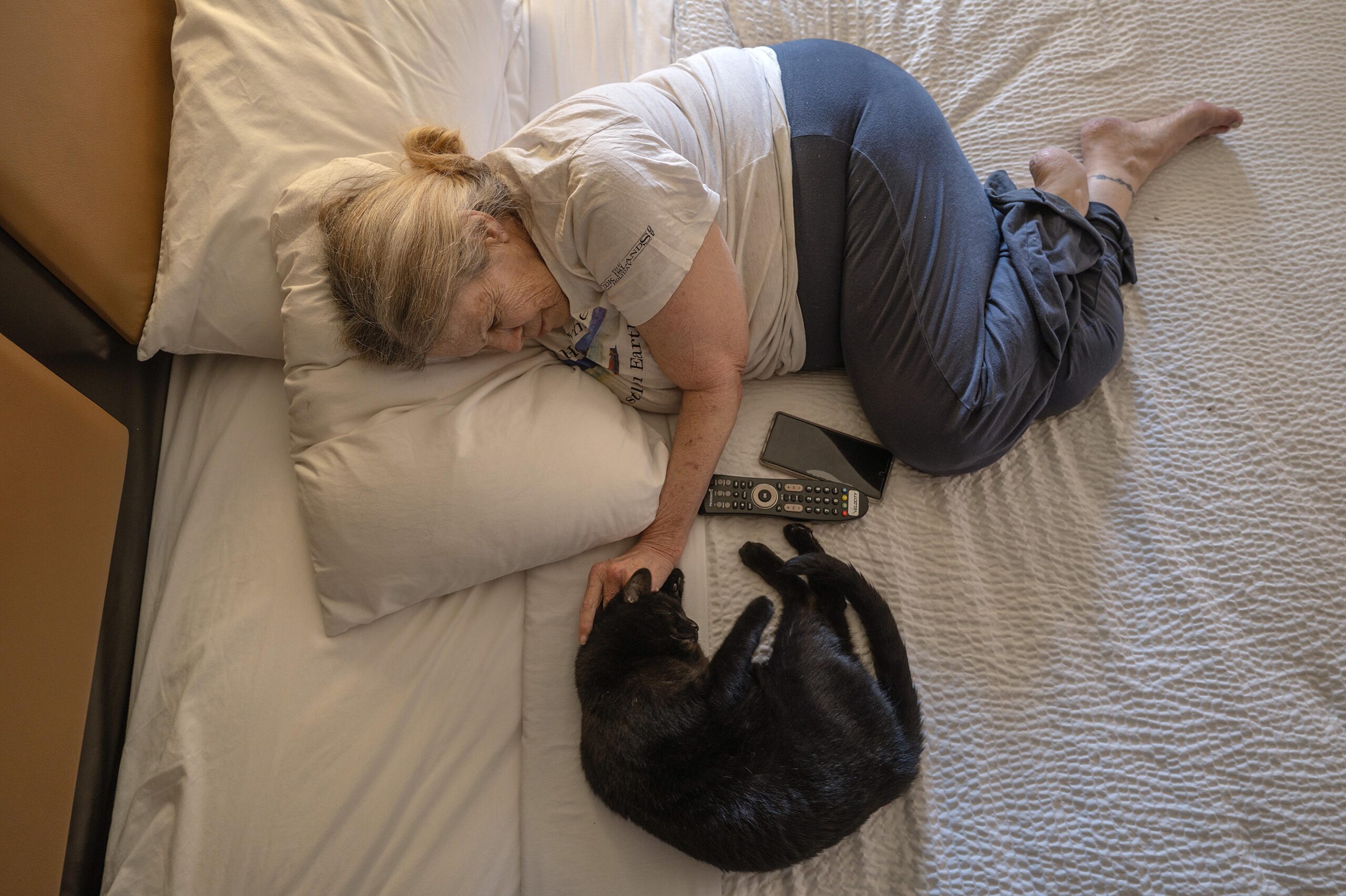 Erickson plays with her beloved cat, Muriel, in the hotel she stayed at after being evicted from her home.